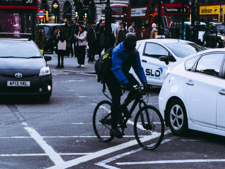 Photography of cyclist in traffic