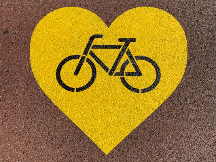 Photograph of road marking showing a bicycle in a yellow heart